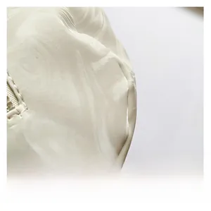 Macro detail of white marble pattern fabric with smooth satin finish and zipper