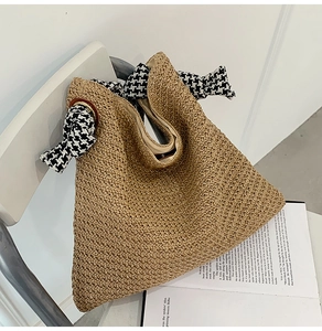 Detailed weave of beige woven tote bag with houndscotton bow detail on a white chair
