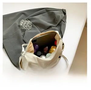 Top view showing large capacity interior of beige tote bag with daily essentials