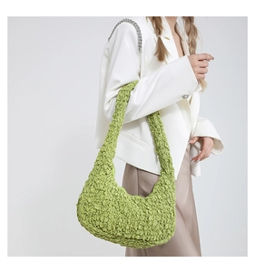 Dettaglio della borsa hobo a mezzaluna verde avocado con texture a pieghe eleganti