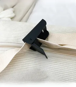 Close-up of adjustable plastic buckle and cream woven strap on corduroy crossbody bag