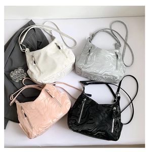 Flat lay of four high-capacity minimalist tote bags in white, silver, pink, and black colors