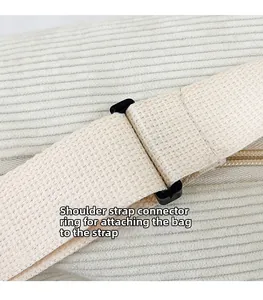 Close-up of corduroy texture and adjustable shoulder strap buckle on this chic bag