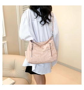 Pale pink marble texture large capacity shoulder bag shown on model in cozy interior