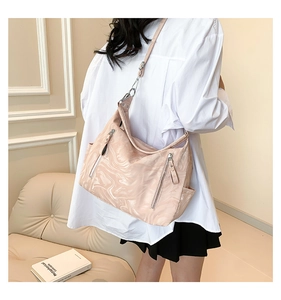 Detailed side view of pink marble pattern tote bag with silver zippers and adjustable strap