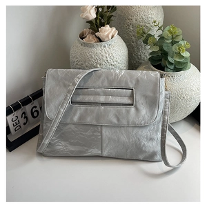 Silver envelope clutch bag with crinkled texture and sleek shoulder strap detail