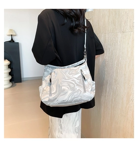 Detail view of silver gray marble pattern bag with smooth satin finish and side zippers