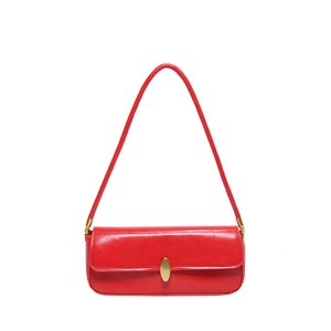 Chic red faux leather underarm baguette bag with elegant golden oval buckle and slim strap