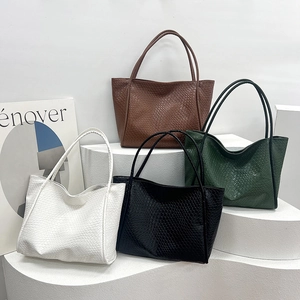 Retro oversized woven tote bags in four colors on minimalist geometric stairs