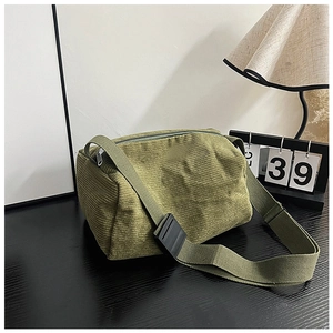 Macro view of olive green corduroy boston bag fabric with a wide adjustable strap