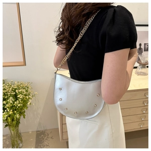 Silver crescent underarm bag with sparkling rhinestones and delicate gold chain strap