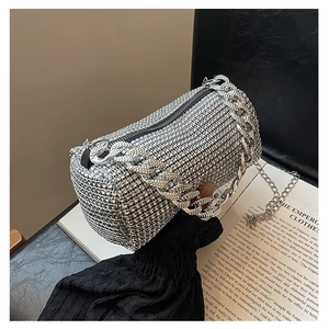 Detailed view of silver rhinestone cylinder evening bag with chunky metal chain handle