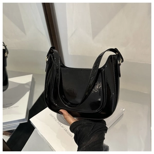 Glossy black patent leather underarm bag with sleek metallic side buckle details