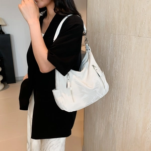 Minimalist white tote bag with marble texture and silver zippers for daily commute