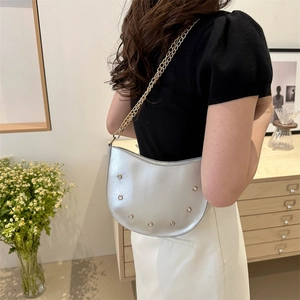 Minimalist silver crescent shoulder bag with metal chain strap and rivet details