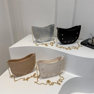 Chic half-moon crossbody bags with metallic studs and chain straps in four colors