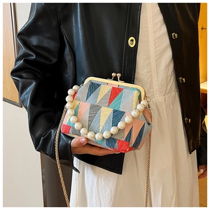 Retro kiss-lock shell bag with colorful geometric patterns and pearl handle detail