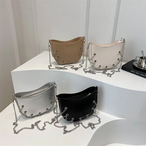 Modern half-moon chain bag in four colors displayed on minimalist podium