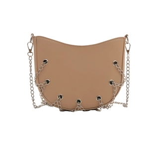 Beige half-moon crossbody bag with silver chain details and metal eyelets on white background