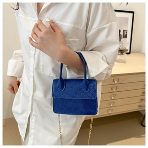 Detailed macro view of the blue lychee texture mini bag with elegant gold chain strap