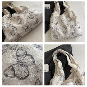 Detail view of jacquard butterfly shoulder bag with textured fringe and floral patterns