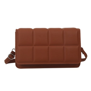 Caramel quilted faux leather crossbody bag with adjustable strap and silver metal buckle