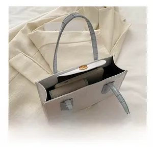 Detailed interior view of white croc-embossed tote bag showing spacious capacity