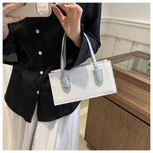 Detail of white crocodile texture PU leather handbag with light blue handle and zipper