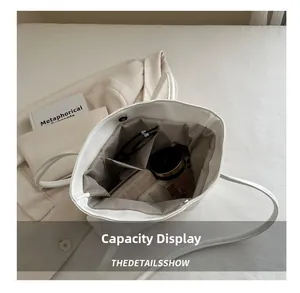 Internal view of a spacious white tote bag showing compartments and daily essentials