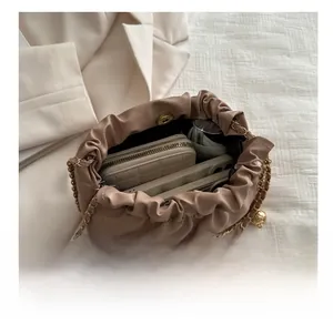 Detail showing spacious interior of the beige quilted cloud bag with everyday essentials