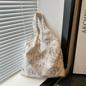 Off-white tote bag with gray butterfly prints and fuzzy textured fringe edges