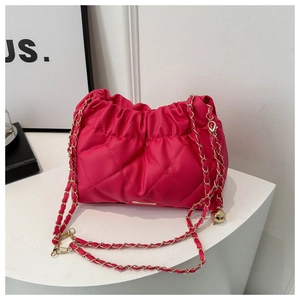 Detail of rose red quilted nylon bag featuring pleated cloud design and gold chain strap