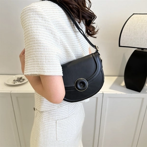 Minimalist black leather saddle shoulder bag with golden round buckle for women