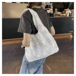 Detail of white canvas tote bag with 3D lace butterfly embroidery and wide shoulder strap