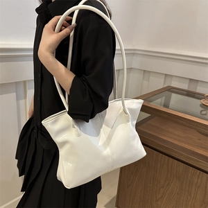 Minimalist white glossy leather tote bag with long handles for stylish daily commuting