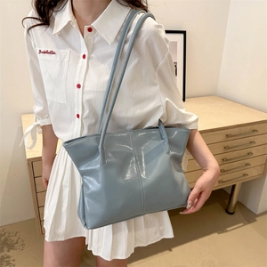 Large light blue patent leather tote bag with minimalist glossy finish for women