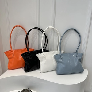 Large minimalist tote bags in orange, black, white, and blue with high-gloss finish