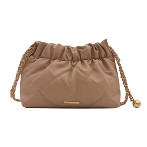 Brown quilted crossbody bag with golden chain strap and ball ornament on white background