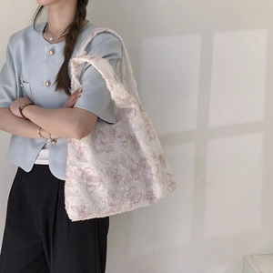 Summer canvas tote bag with pink lace butterfly prints carried by a model on shoulder