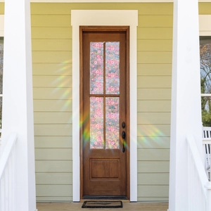 Detail of pink floral static window film with rainbow effect on a brown wooden door