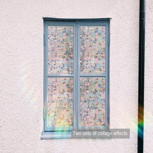 Detail of floral window film with pink blossoms and colorful mosaic texture on glass