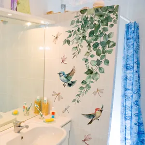 Detail of floral wall stickers with green leaves, blue birds and dragonflies on tile