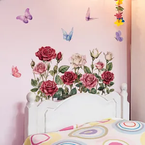 Close-up of watercolor floral and butterfly wall stickers on a soft pink bedroom wall