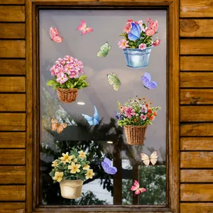 Détail de pots de fleurs et papillons autocollants statiques sur une surface vitrée