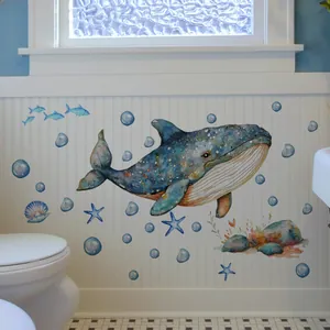 Detailed watercolor blue whale wall decal with sea stars and bubbles on a white panel