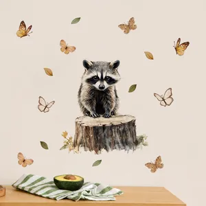 Detail showing hand-painted watercolor raccoon and butterfly wall stickers on a light wall