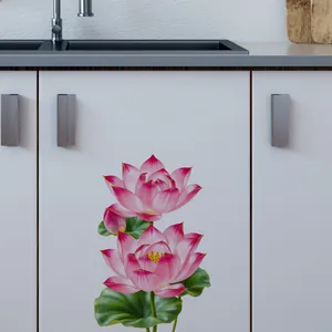 Detail of pink lotus wall stickers applied to white cabinets in a kitchen setting