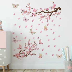 Detail of pink cherry blossom wall stickers with butterflies on a white living room wall