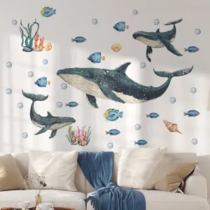 Detail of watercolor whale wall stickers featuring corals and tropical sea fish on living room wall