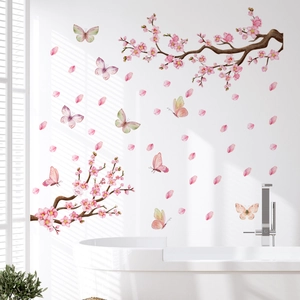Detail of pink cherry blossom wall decals with butterflies on a modern bathroom wall